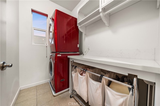 laundry room with laundry area, stacked washing maching and dryer, baseboards, and light tile patterned flooring