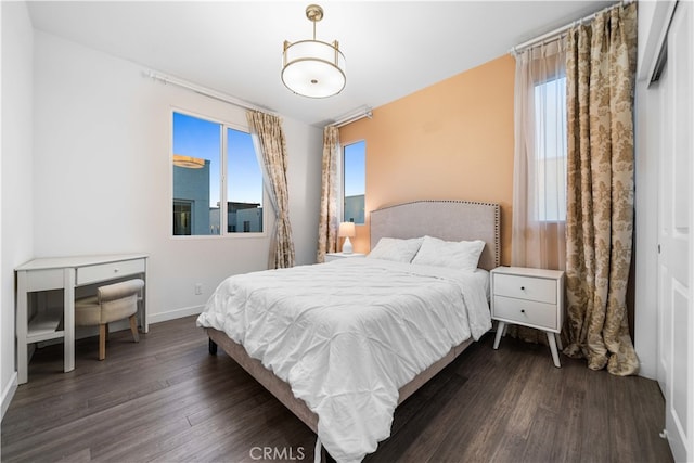 bedroom with baseboards and wood finished floors