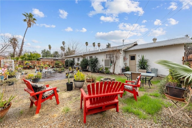 view of yard featuring a patio area, fence, and a fire pit