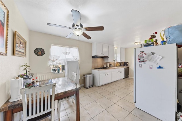 kitchen featuring decorative backsplash, dishwasher, freestanding refrigerator, gas stovetop, and white cabinetry