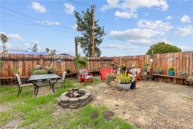 view of yard featuring an outdoor fire pit and a fenced backyard