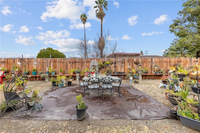 view of patio with outdoor dining space and a fenced backyard