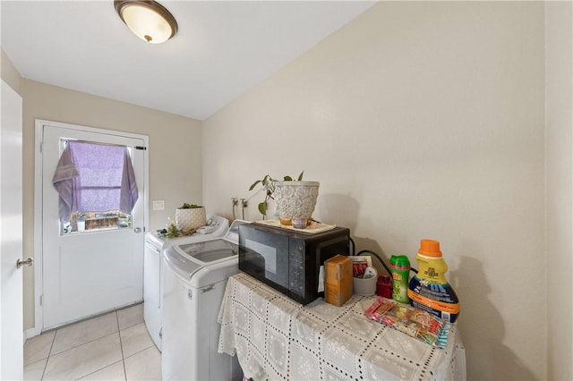 clothes washing area with light tile patterned floors, laundry area, and independent washer and dryer