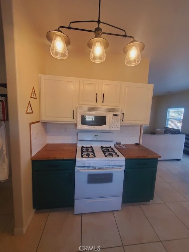 kitchen with white appliances, tasteful backsplash, light tile patterned floors, butcher block counters, and white cabinetry