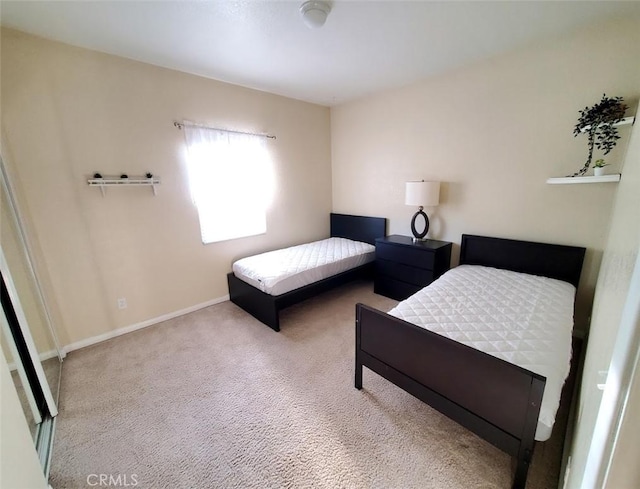 carpeted bedroom with baseboards