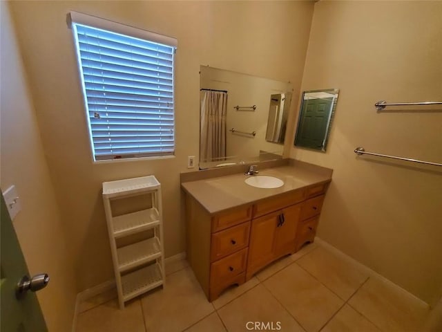 full bathroom featuring baseboards, curtained shower, vanity, and tile patterned floors