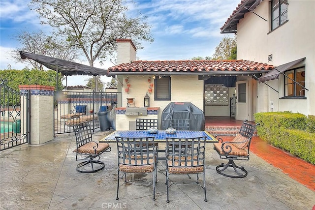 view of patio with outdoor dining area and grilling area