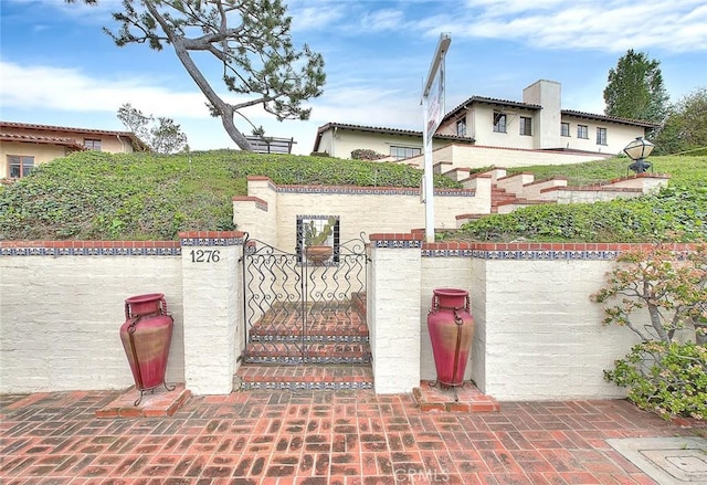 exterior space with a fenced front yard and a gate