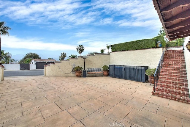 view of patio featuring a gate and fence