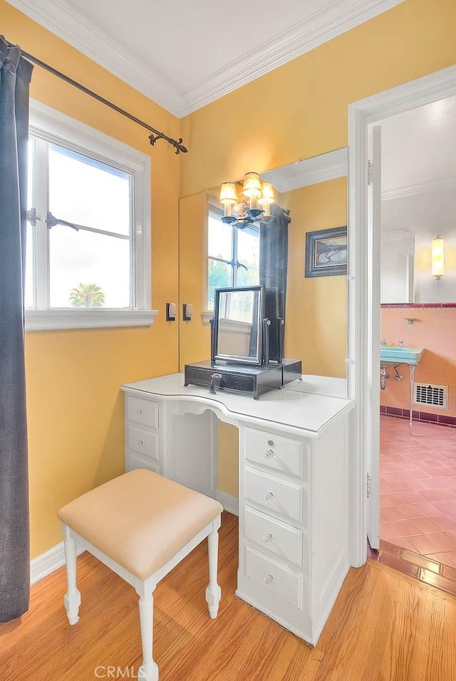 bathroom featuring visible vents, crown molding, and wood finished floors