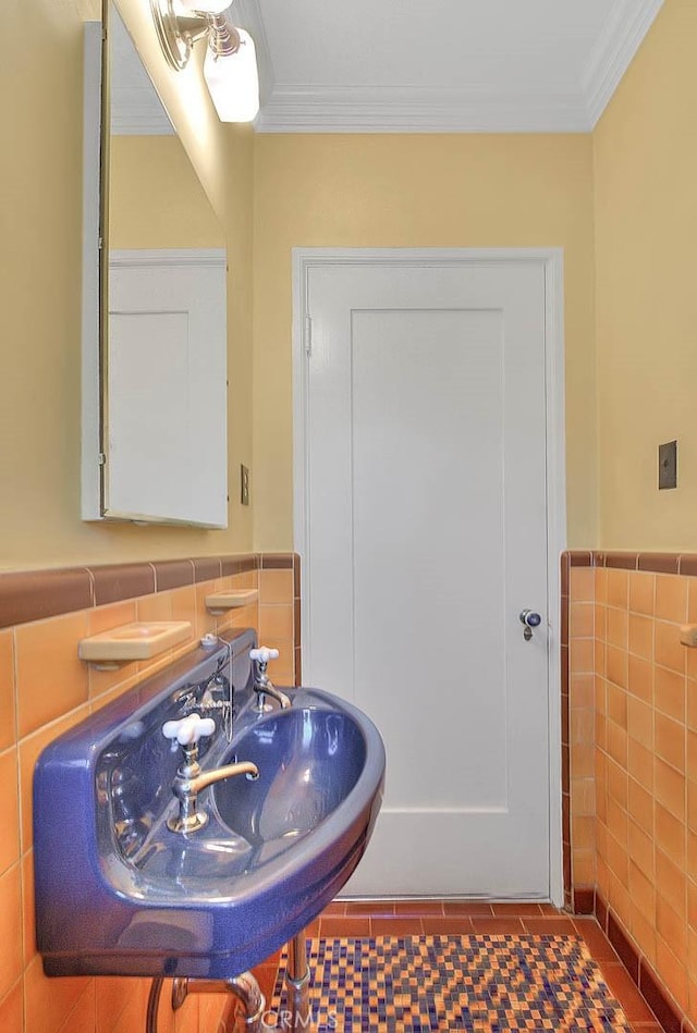 bathroom featuring tile walls, a wainscoted wall, and ornamental molding