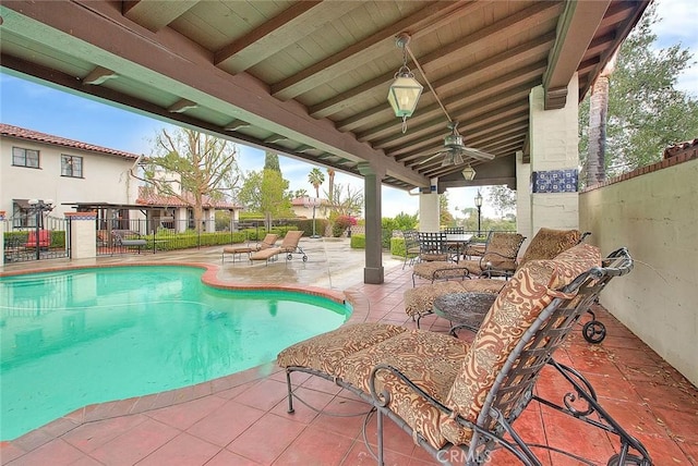 view of swimming pool featuring a fenced in pool, ceiling fan, a patio, and fence