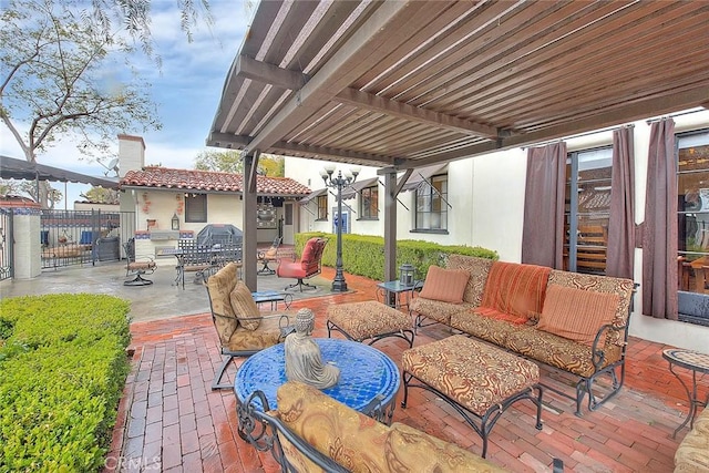 view of patio featuring area for grilling, an outdoor hangout area, and fence