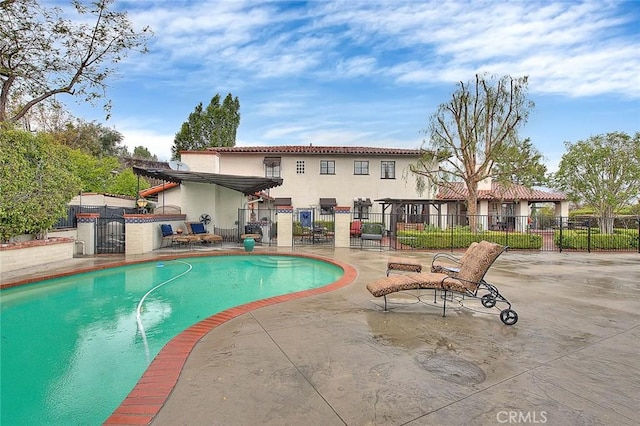 view of swimming pool with a patio area, a fenced in pool, and fence