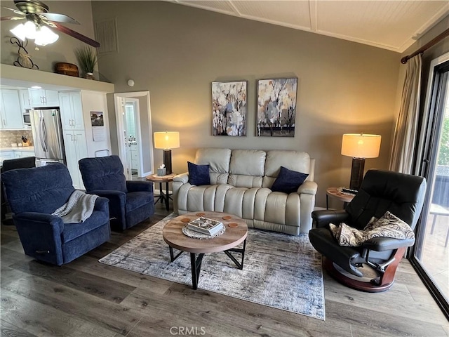 living room with ceiling fan, crown molding, vaulted ceiling, and wood finished floors