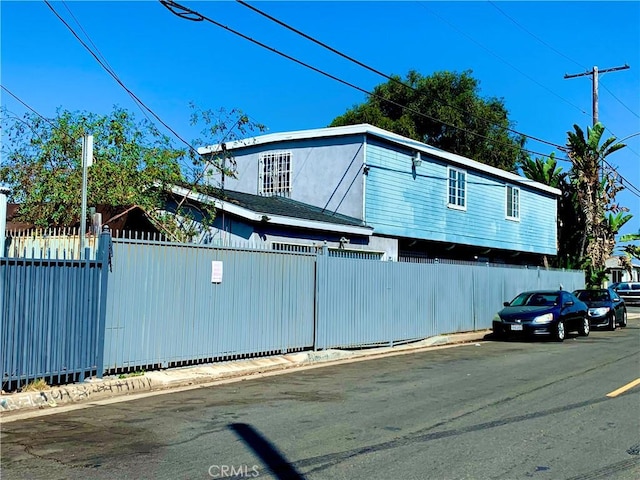 view of home's exterior with a fenced front yard and stucco siding