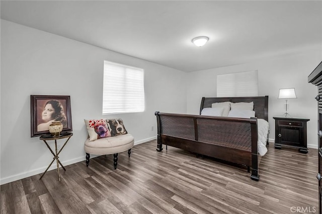 bedroom featuring baseboards and wood finished floors