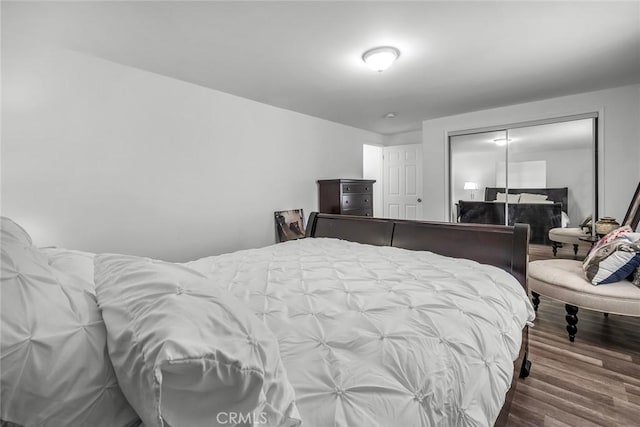 bedroom with a closet and wood finished floors