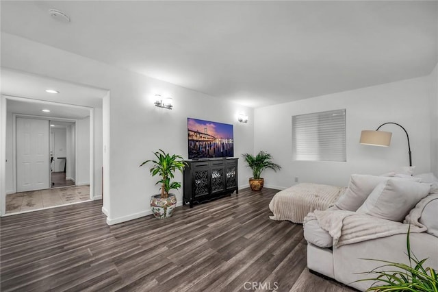 living room featuring baseboards and wood finished floors