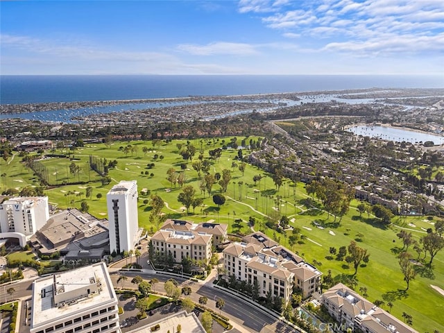 aerial view with golf course view and a water view