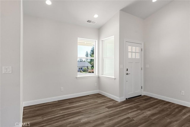 entrance foyer featuring dark wood-style floors, baseboards, visible vents, and recessed lighting