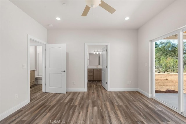 unfurnished bedroom with baseboards, dark wood finished floors, ensuite bath, access to outside, and recessed lighting