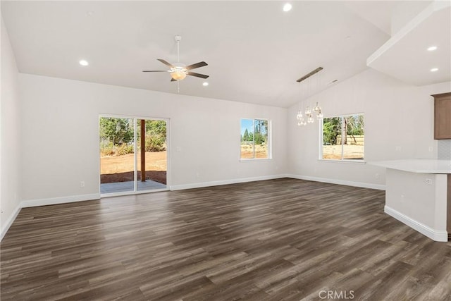 unfurnished living room with dark wood-style floors, a healthy amount of sunlight, and vaulted ceiling