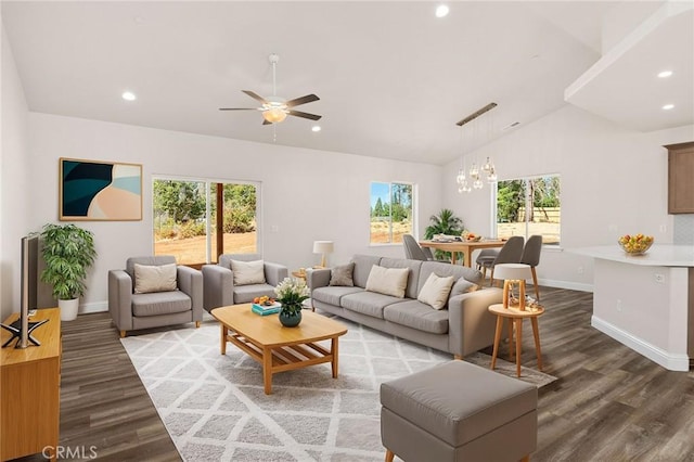 living area featuring a healthy amount of sunlight, vaulted ceiling, and wood finished floors