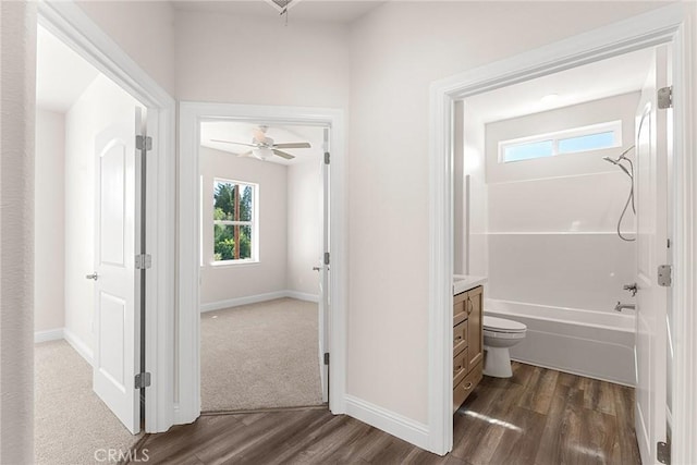 full bath with baseboards, wood finished floors, and vanity