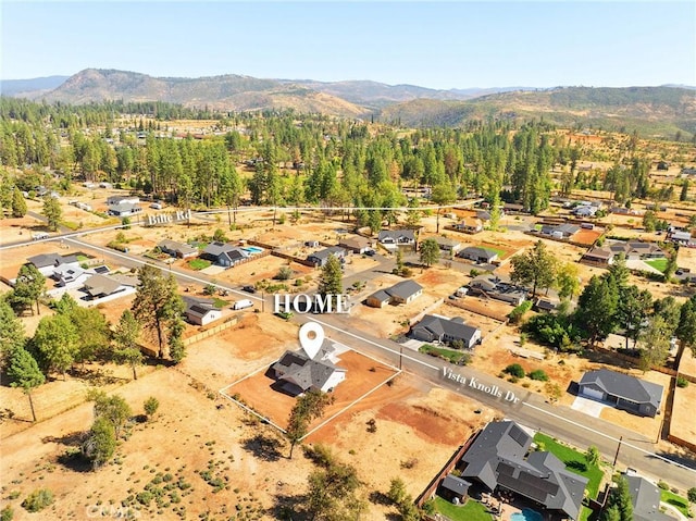 drone / aerial view featuring a mountain view and a wooded view