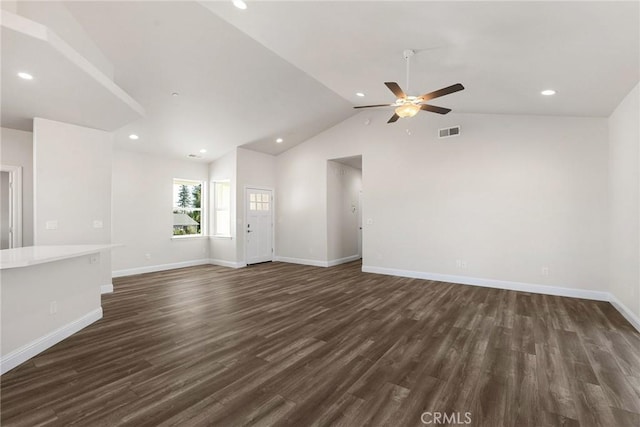 unfurnished living room featuring dark wood-type flooring, visible vents, baseboards, vaulted ceiling, and a ceiling fan