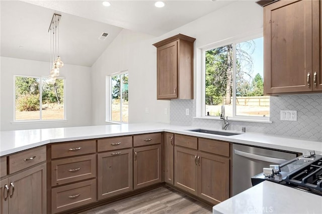 kitchen with light countertops, visible vents, a sink, and lofted ceiling