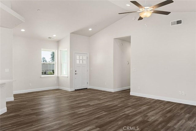 interior space featuring vaulted ceiling, dark wood-style flooring, visible vents, and baseboards