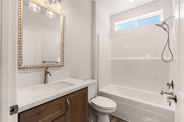 full bathroom with washtub / shower combination, vanity, and toilet