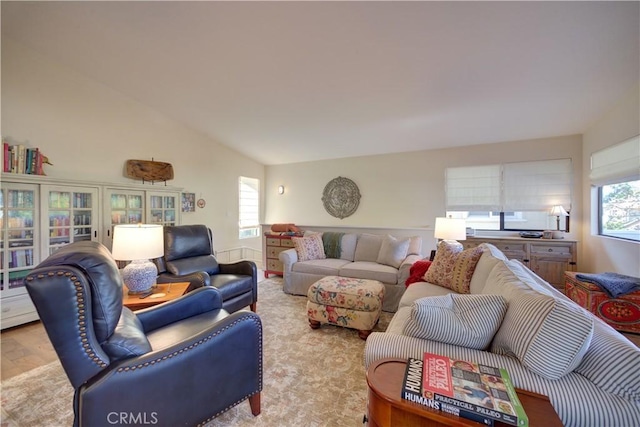 living area featuring wood finished floors and vaulted ceiling