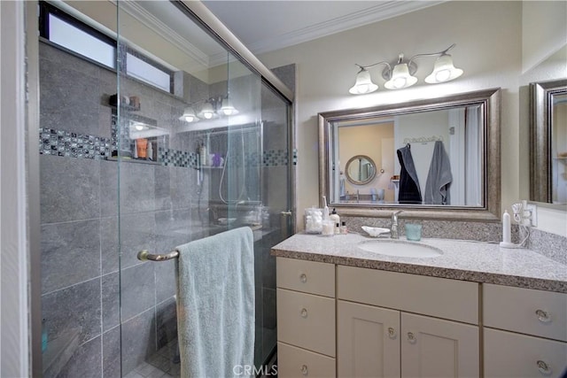 bathroom with vanity, crown molding, and a stall shower