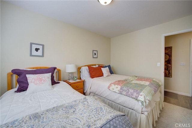 bedroom with baseboards and wood finished floors