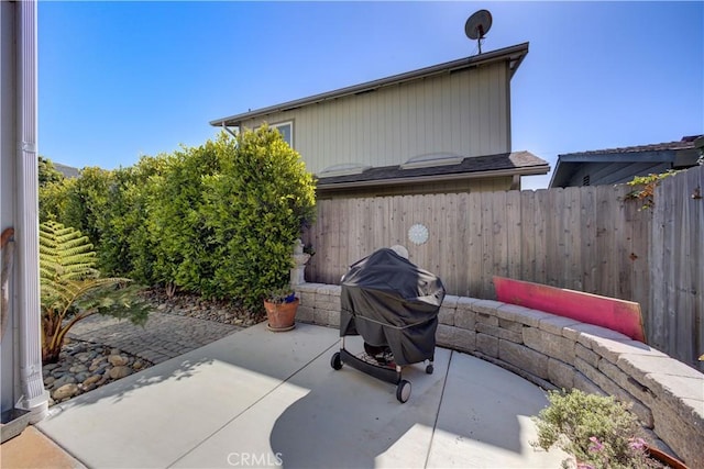 view of patio / terrace featuring fence and a grill