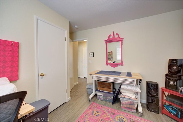 interior space with baseboards and wood finished floors