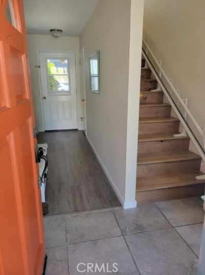 interior space featuring stairs, tile patterned floors, and baseboards