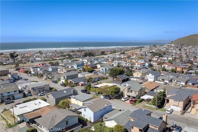 drone / aerial view featuring a residential view and a water view