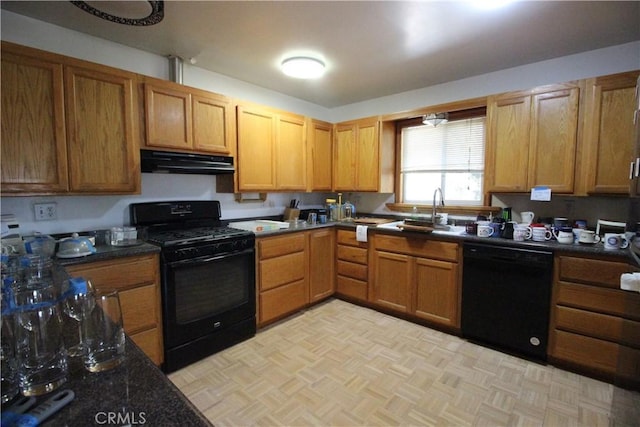 kitchen featuring black appliances, a sink, and under cabinet range hood