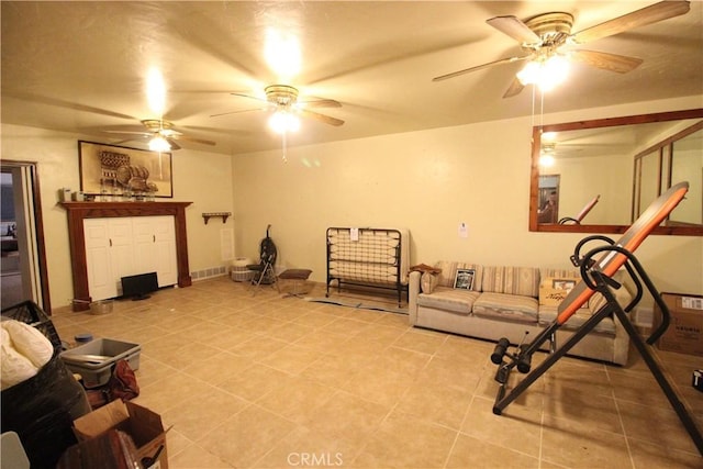 tiled living room featuring ceiling fan