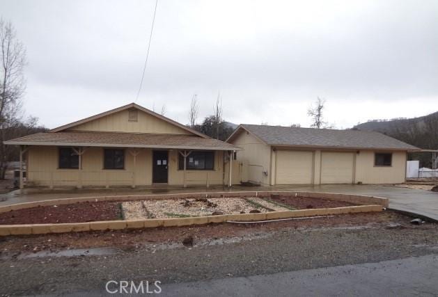 view of front of house with a porch and concrete driveway