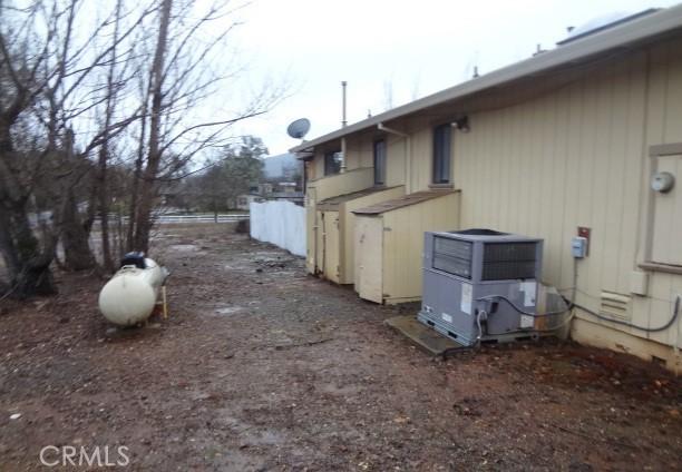 view of side of property with central AC unit