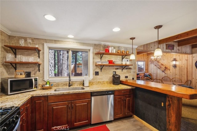 kitchen with open shelves, a peninsula, stainless steel appliances, and a sink