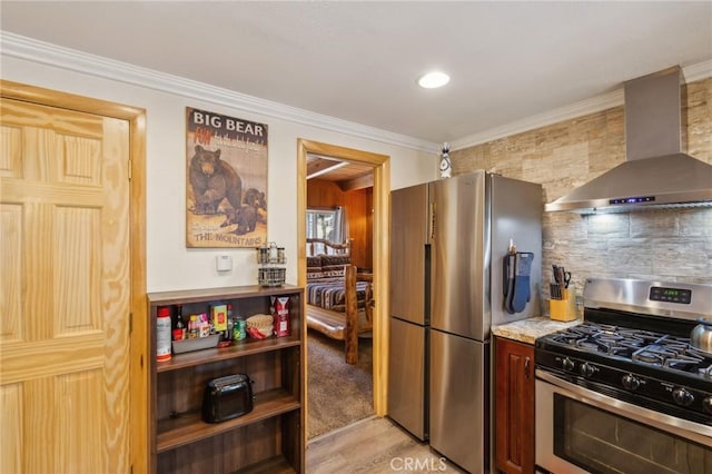 kitchen featuring light countertops, ornamental molding, appliances with stainless steel finishes, backsplash, and wall chimney exhaust hood