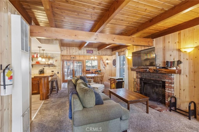 living room featuring wooden ceiling, wood walls, a fireplace, and beamed ceiling