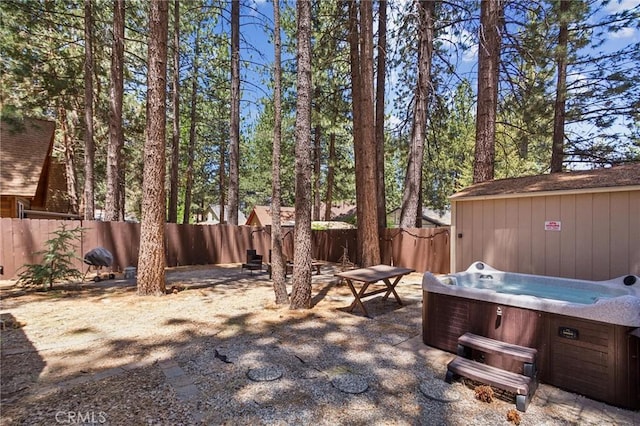 view of patio / terrace with a hot tub and a fenced backyard