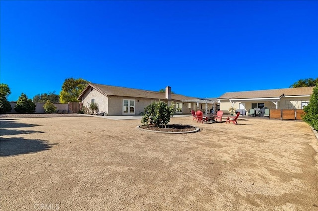 back of house with a patio area, fence, and stucco siding